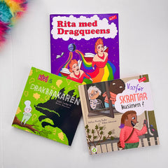 Målarboken Rita med dragqueens syns på vit träyta med bilderböckerna Kivi & drakbrakaren & Varför skrattar kusinen?