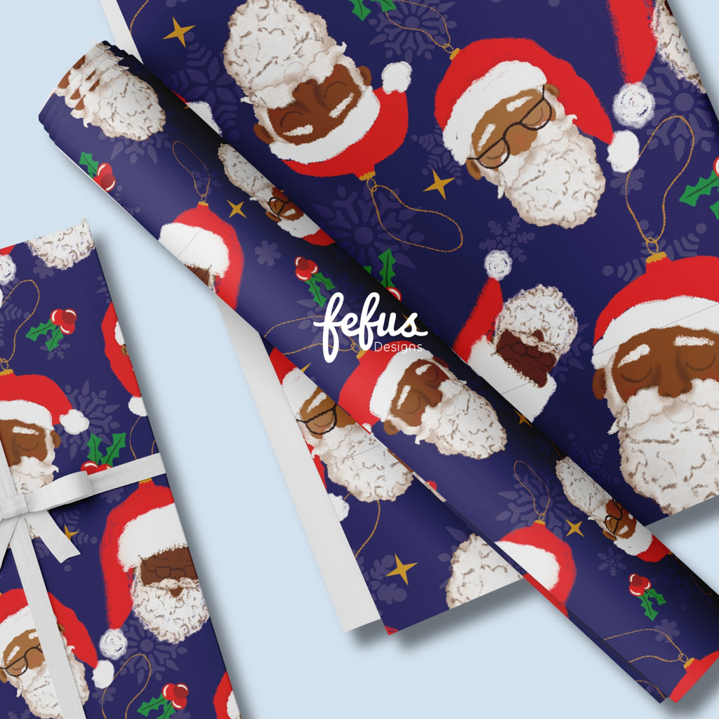 Julpapper med illustrationer av tomteansikten med brun hudfärg och texten ”FEFUS DESIGNS” tryckt på bilden.