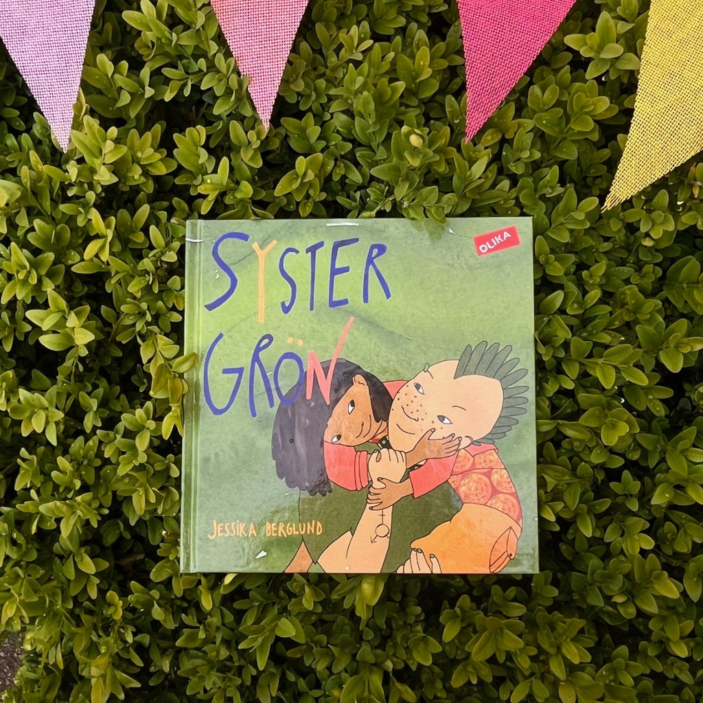 Barnboken Syster Grön, en grön buske och färgglada vimplar 