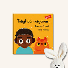 Pekboken Tidigt på morgonen på en vit yta. I nedre hörnet syns en gosedjurskanin som vilar ett öra på boken