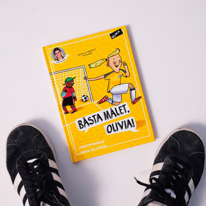 Kapitelboken Bästa målet, Olivia! syns på vit yta tillsammans med ett par fotbollsskor